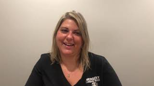 Snapshot of a woman with blonde hair wearing a black shirt.