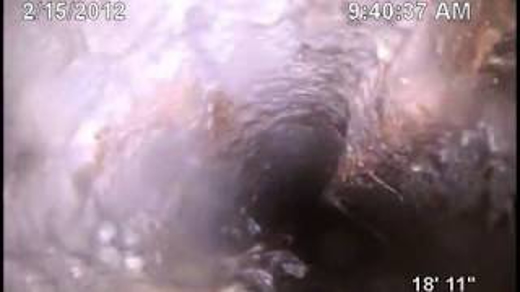 This is a blurry snapshot, dated 2/15/2012 at 9:40:37 AM, seemingly taken from within a pipe or other narrow, dark space.