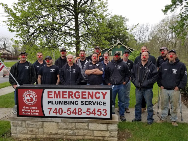 We Love Our Community 12 A team from Emergency Plumbing Services is posing for a group photo while wearing Red Noses